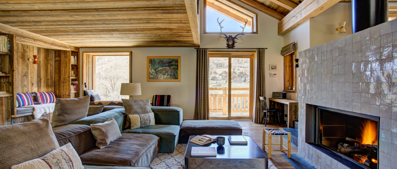 Chalet Bergeronnette, Meribel - large fire in the living room with coffee table and sofas